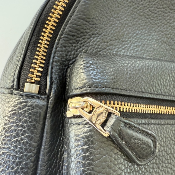 coach black leather mini backpack 1990s in Refined pebble leather Inside zip cell phone and multifunction pockets Laptop compartment with zip closure Zip closure recycled polyester lining Top handle with 2 drop Outside zip pockets Adjustable shoulder straps Fits a 12 (zip compartment) or 13 (main compartment) laptop 10 3/4 (L) x 14 (H) x 5 1/4 (W) Style No. Taylor Small Backpack | Bags